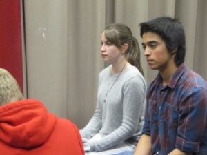 Kyra and her costar, Emilio, listen as other actors rehearse their lines.